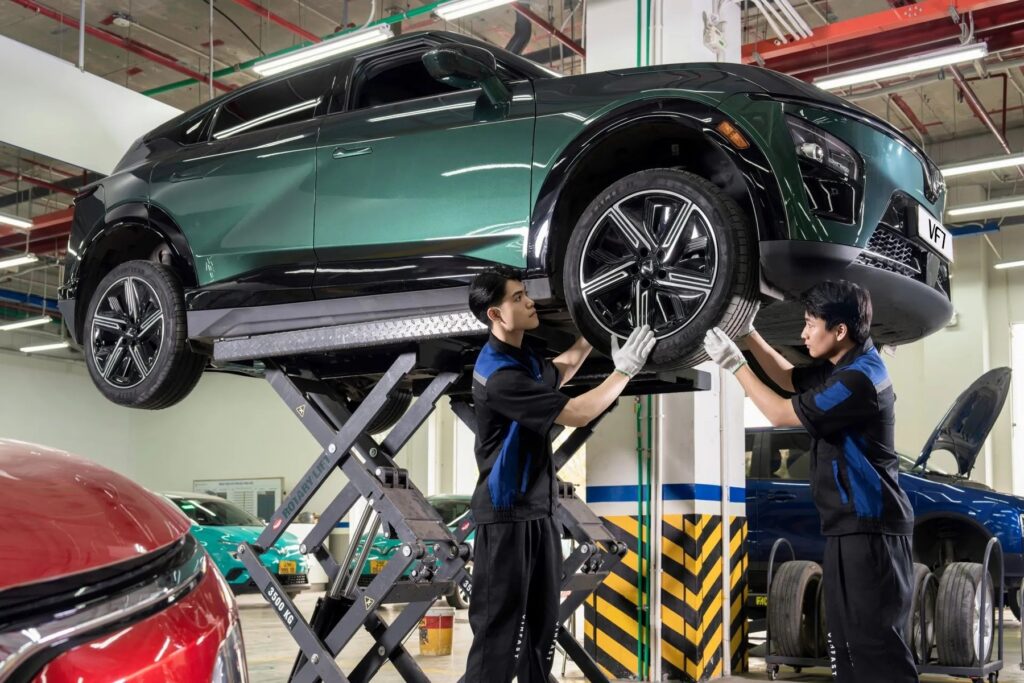 Kỹ thuật viên kiểm tra lốp xe điện VinFast trên cầu nâng tại xưởng dịch vụ